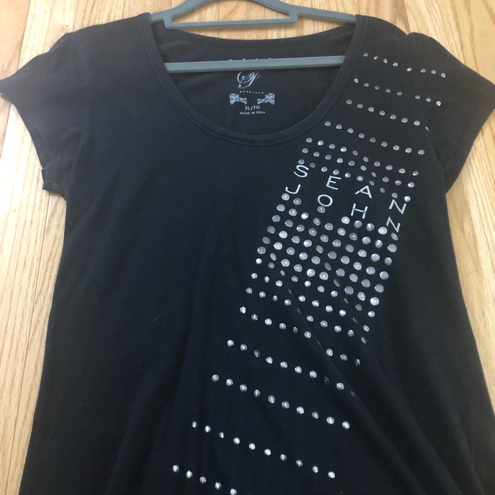 A black shirt with silver stone detailing.